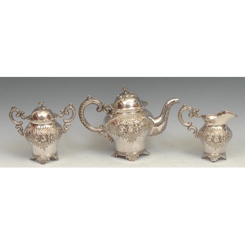 548 - A Chinese silver three piece inverted baluster tea service, comprising teapot, milk jug and sucrier,... 