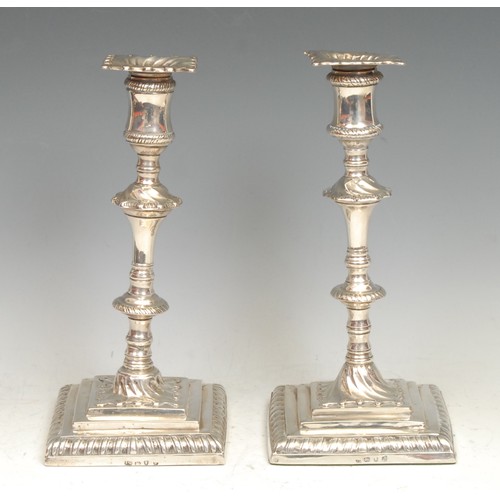 550 - A composed pair of early George III silver square table candlesticks, detachable nozzles, knopped pi... 