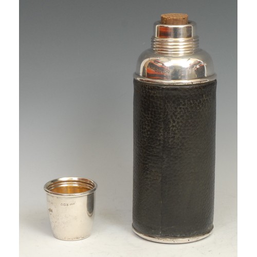 816 - An unusual Edwardian silver thermos flask, the screw-fitting cover a cup, leather bound, 26cm high, ... 