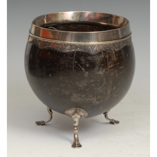 743 - An 18th century silver coloured metal mounted coconut cup, pad feet, 11.5cm high, c.1760