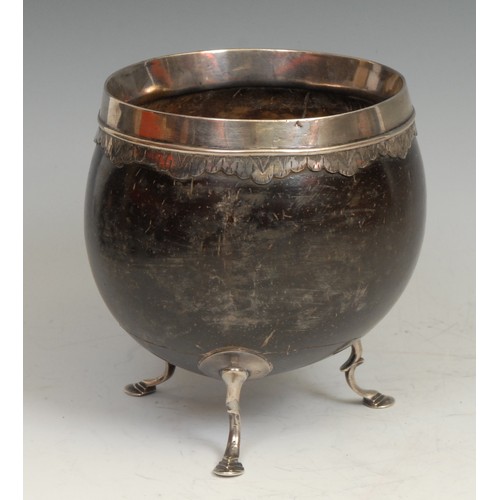 743 - An 18th century silver coloured metal mounted coconut cup, pad feet, 11.5cm high, c.1760