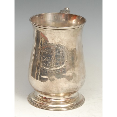 765 - An early George III silver bell shaped pint mug, acanthus-capped double scroll handle, skirted base,... 