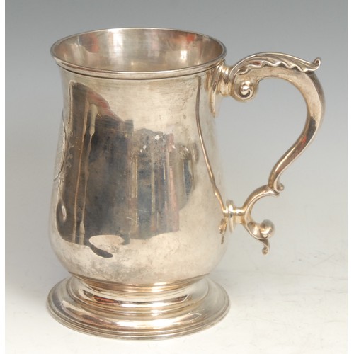 765 - An early George III silver bell shaped pint mug, acanthus-capped double scroll handle, skirted base,... 