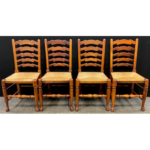 71 - A set of four oak ladder-back dining chairs, early 19th century style, rush seats, turned stretchers... 