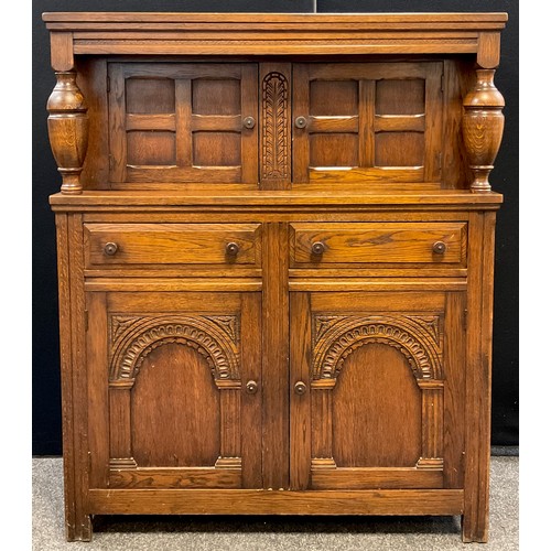 80 - An oak court cupboard, turned decorative supports, with pair of small cupboard doors to top, the bas... 