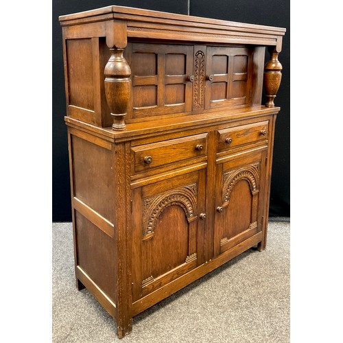 80 - An oak court cupboard, turned decorative supports, with pair of small cupboard doors to top, the bas... 