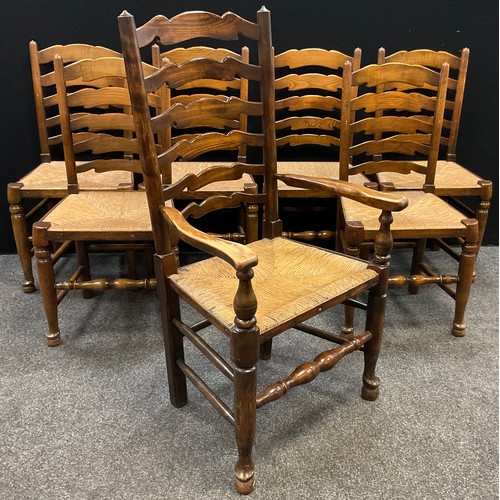 85 - A set of six ladder-back 19th century style elm dining chairs, and a matching carver chair, rush sea... 