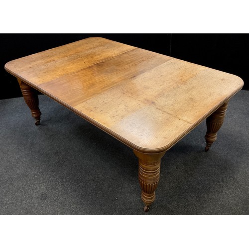 90 - A Victorian oak extending dining table, rounded rectangular top, with single additional leaf, large ... 