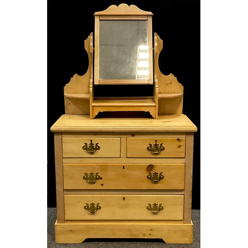 197 - A pine dressing chest, dressing mirror top with shaped supports and three small shelves, above a bas... 