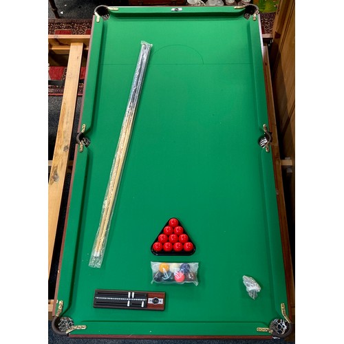 259 - A Pot Black snooker table, two cues, balls etc  183cm x 91.5cm.