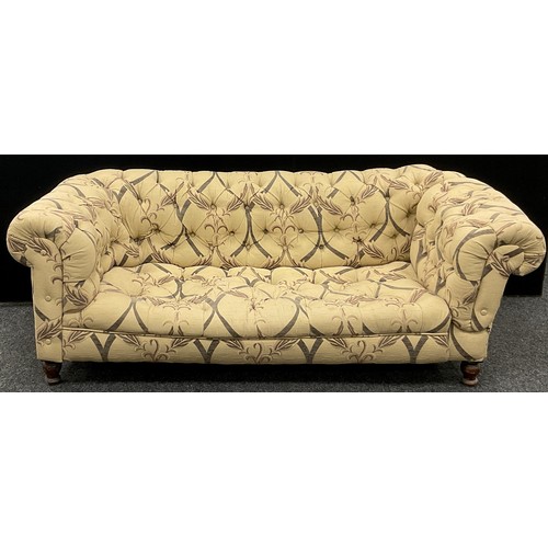 273 - A Chesterfield sofa, deep button-back, fabric upholstery, turned legs, 65cm high x 182cm wide x 89cm... 