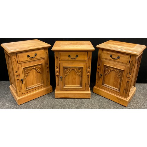 104 - Three pine gothic style bedside cabinets, each with a single drawer to frieze, above a single cupboa... 