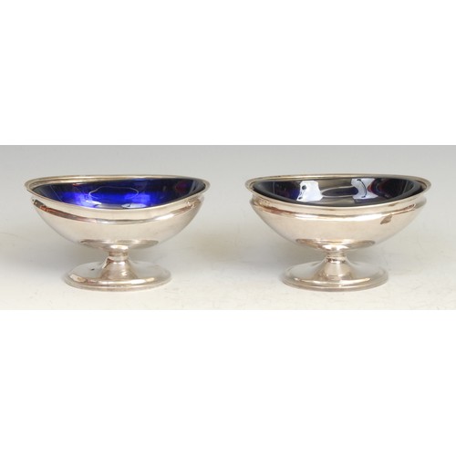 483 - A pair of Chinese silver oval pedestal salts, blue glass liners, 11cm wide, character marks, c.1890,... 