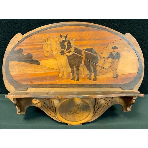 296 - An Art Nouveau period marquetry pipe rack, inlaid with a ploughman at work, c.1910