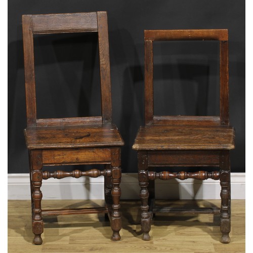 1227 - A harlequin pair of 18th century oak backstools, boarded seats, H-stretchers, the largest 85.5cm hig... 