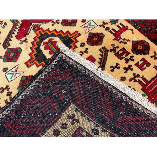 299 - A North-east Persian Meshed Belouch rug, hand-knotted with double diamond-form medallions within a c... 