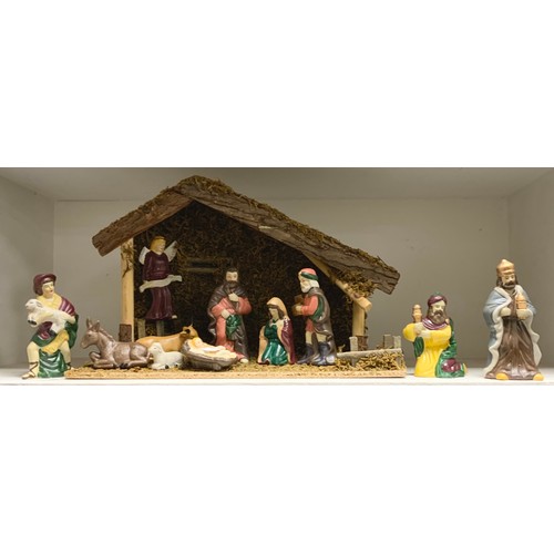 170 - A continental hand painted porcelain nativity scene with figures, animals and a conforming barn