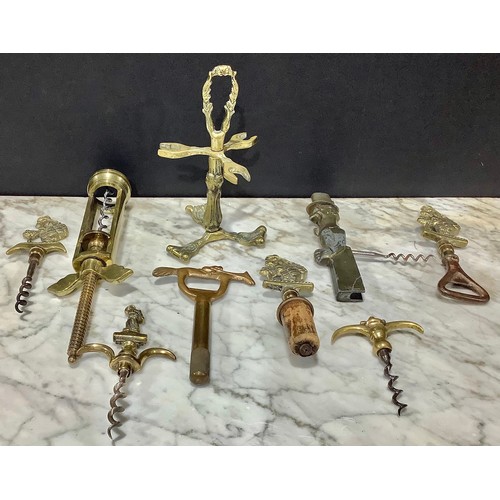 2469 - Helixophilia - A brass and steel crinoline lady bar set, corkscrew, bottle opener and cork bottle st... 