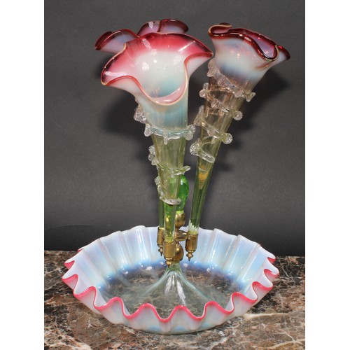 336 - A Victorian cranberry and vaseline glass epergne, wavy-edge circular base, three trumpet branches wi... 