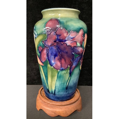 5043 - A Moorcroft Orchid pattern tapering cylindrical shoulder vase, tube lined with bold flowerheads on a... 