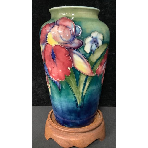 5043 - A Moorcroft Orchid pattern tapering cylindrical shoulder vase, tube lined with bold flowerheads on a... 