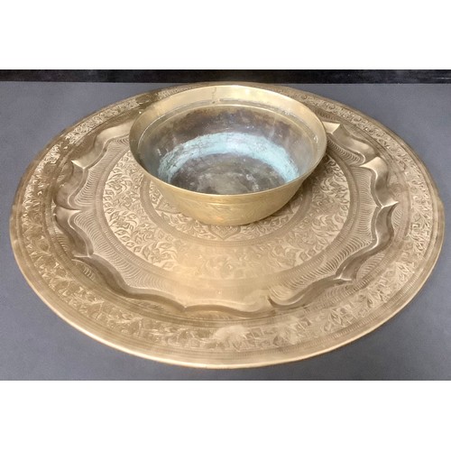 5179 - A Chinese brass bowl, engraved with dragons and ships, 25cm diameter; a Persian style circular tray,... 