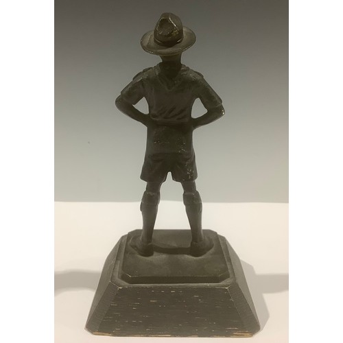 5116 - A patinated bronze figure, of a Boy Scout, oak base, 13cm high