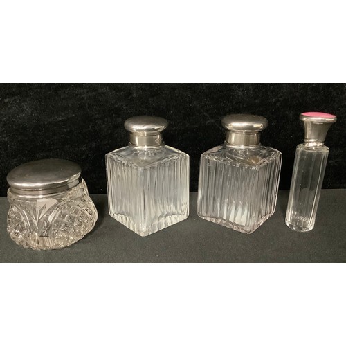 5122 - A pair of early George V clear glass facetted square scent bottles, domed silver covers, clear glass... 