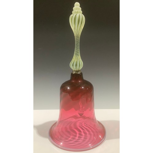 5124 - A large Victorian cranberry glass bell, uranium and opaque glass twist handle, wrythen glass bell wi... 