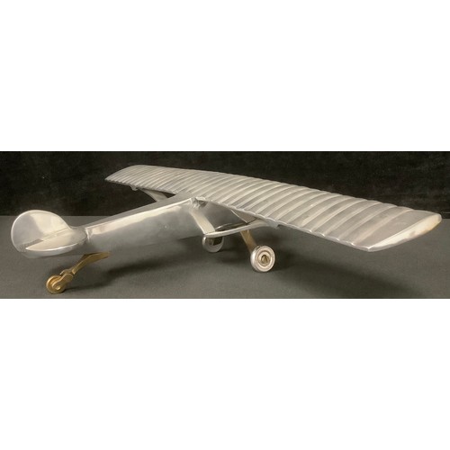 5222 - An aluminium desk model of Charles Lindbergh's Spirit of St. Louis monoplane in which he made the fi... 