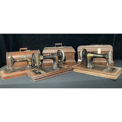 5235 - An early 20th century Frister & Rossman hand cranked sewing machine, cased; others, Singer, etc (3)