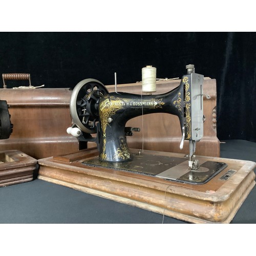 5235 - An early 20th century Frister & Rossman hand cranked sewing machine, cased; others, Singer, etc (3)