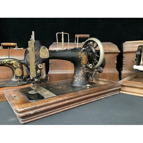 5235 - An early 20th century Frister & Rossman hand cranked sewing machine, cased; others, Singer, etc (3)