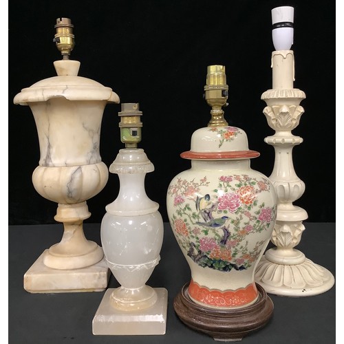 5293 - A large alabaster urn table lamp; another, similar, smaller; a carved wooden lamp; a Chinese vase la... 