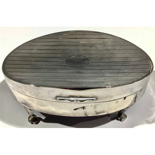 5026 - A silver oval dressing table box, engine turned hinged cover, paw feet, 14cm wide, Chester 1908, 149... 