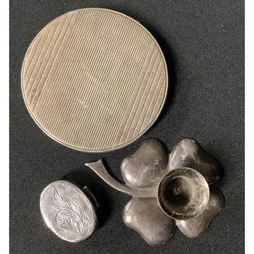 5029 - A silver oval pill box, marked 925; a silver plated miniature candlestick, as a shamrock; a circular... 