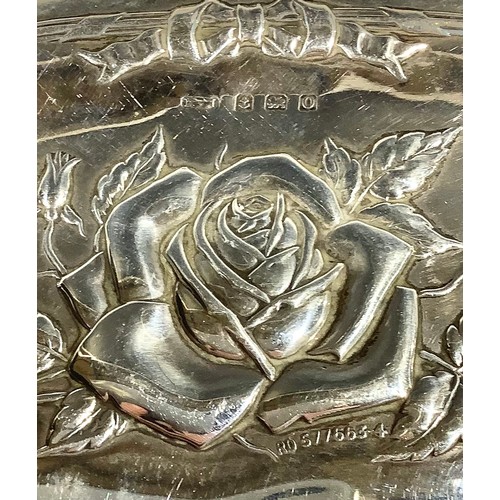 5318 - A George V silver evening purse, embossed with roses and ribbon tied border, 11.5cm wide, Birmingham... 