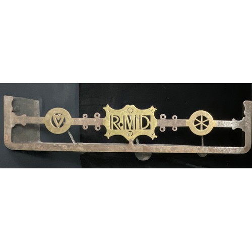 5454 - An early 20th century steel and brass combination fire curb hearth trivet, the centre initialled RMD... 