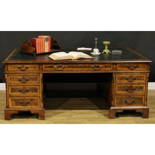 1308A - A George III Revival walnut and mahogany twin pedestal partners’ desk, rectangular top with inset to... 