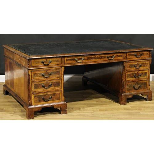 1308A - A George III Revival walnut and mahogany twin pedestal partners’ desk, rectangular top with inset to... 