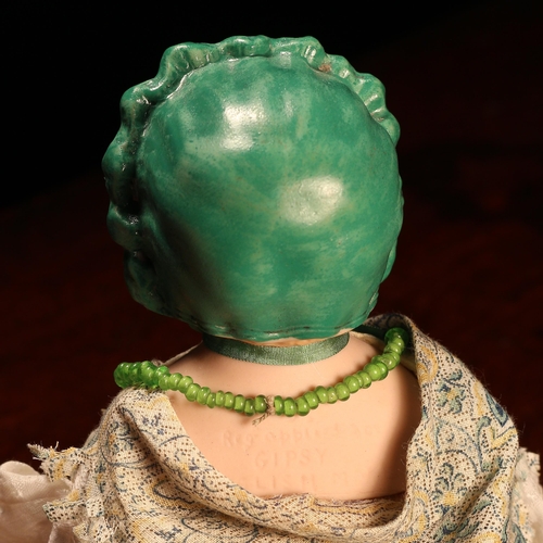 7201 - An English bisque shoulder head doll, modelled as a Gypsy, the bisque head with painted features inc... 