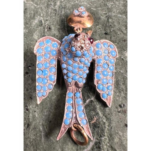 865A - A Belle Époque unmarked dove pendant, set with an arrangement of graduated polished turquoise beads,... 