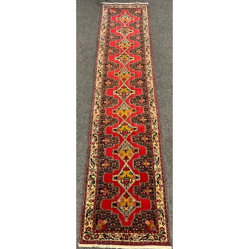 86 - A North West Persian Senneh Runner carpet, 405cm x 85cm.