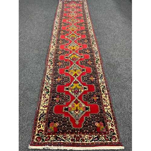 86 - A North West Persian Senneh Runner carpet, 405cm x 85cm.