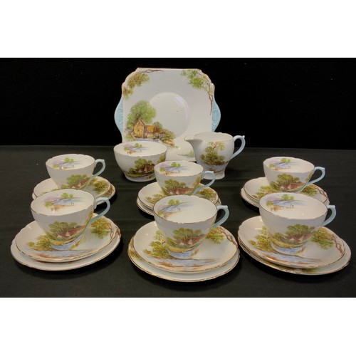 102 - A Shelley ‘Old Mill’ pattern no.13669 comprised of; six tea cups and saucers, milk jug, sugar bowl, ... 