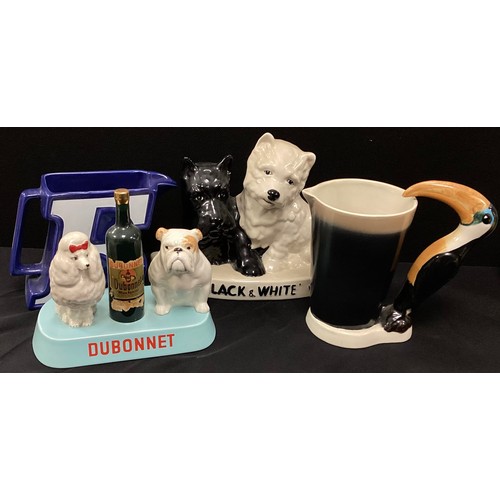 124 - Advertising pottery including;  'Black and White whiskey' by Brentleigh ware,'Dubbonet' by Beswick; ... 