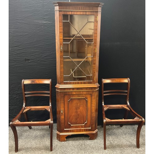 148 - A mahogany corner cabinet by Reprodux Furniture, dentil cornice, astral-glazed door to top, bracket ... 