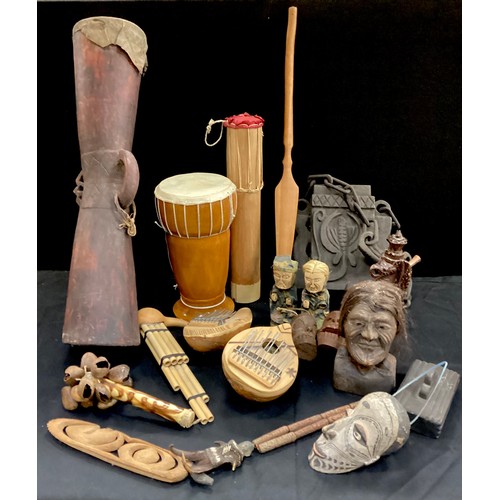 185 - Tribal objects including; a 20th century wooden bitel bag, Kundu drum, carved dragon pipe, shell rat... 