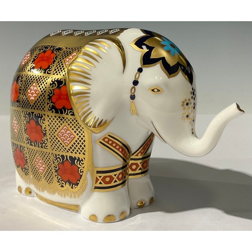 5092 - A Royal Crown Derby paperweight, Imari Baby Elephant, with trunk raised, decorated in the 1128 patte... 