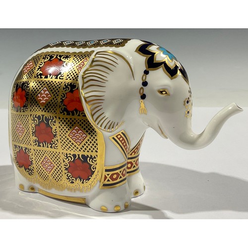 5091 - A Royal Crown Derby paperweight, Imari Baby Elephant, with trunk raised, decorated in the 1128 patte... 